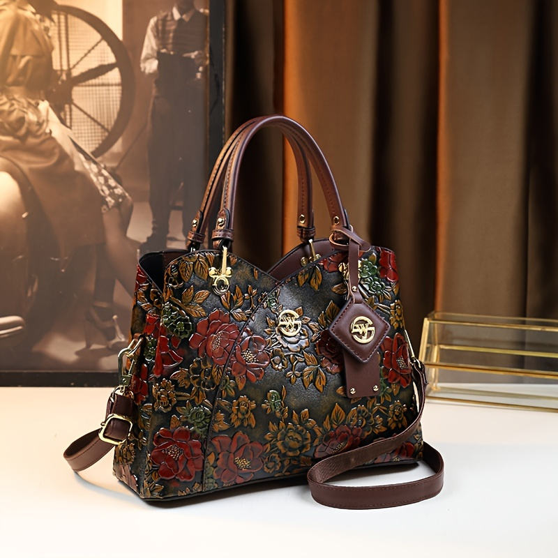 Floral embossed handbag three-quarter view with shoulder strap