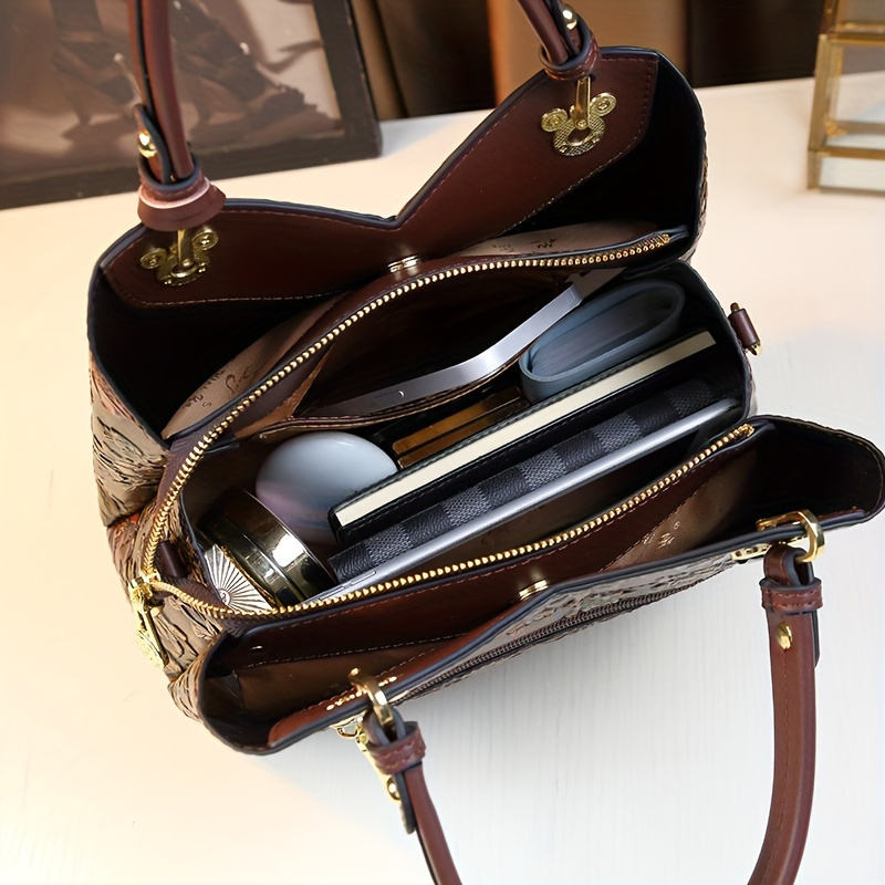 Interior of the handbag with phone, wallet and accessories inside
