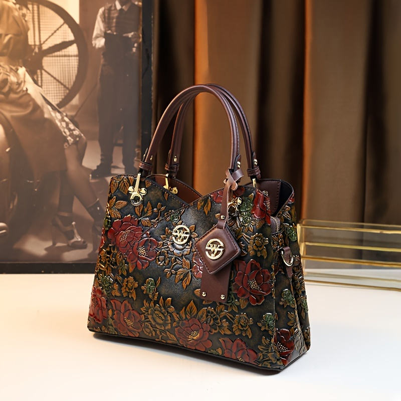 Close-up of the embossed floral pattern and gold-tone hardware